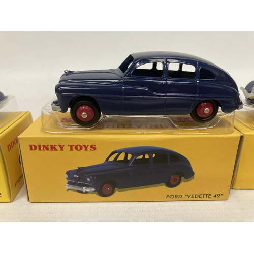 375 - FIVE BOXED DINKY ATLAS MODELS TO INCLUDE A STUDEBAKER COUPE (NO 39F), A PEUGEOT 402 'TAXI' (NO 24L),... 