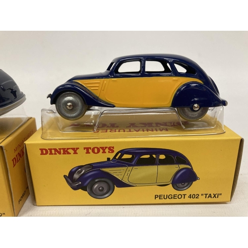 375 - FIVE BOXED DINKY ATLAS MODELS TO INCLUDE A STUDEBAKER COUPE (NO 39F), A PEUGEOT 402 'TAXI' (NO 24L),... 