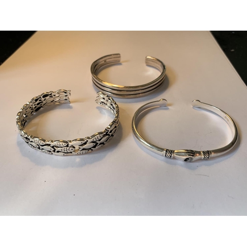 523 - THREE SILVER BANGLES