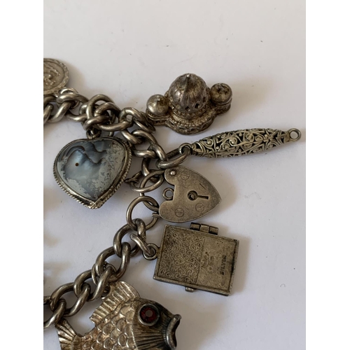 574 - A SILVER CHARM BRACELET WITH FOURTEEN CHARMS