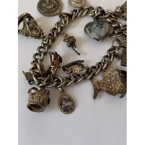 574 - A SILVER CHARM BRACELET WITH FOURTEEN CHARMS