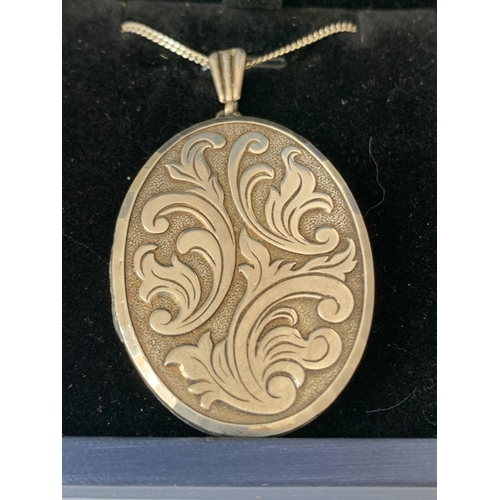 589 - A SILVER LOCKET IN A PRESENTATION BOX