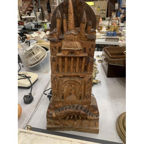 155 - A VINTAGE WOODEN CARVING OF A CASTLE WITH A CREATURE UNDERNEATH SIGNED SOUDANI, HEIGHT 45CM