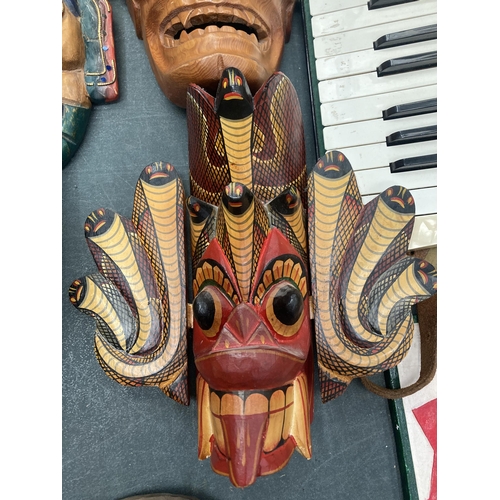 207 - A GROUP OF FIVE VINTAGE TRIBAL WOODEN MASKS