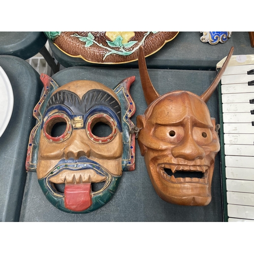 207 - A GROUP OF FIVE VINTAGE TRIBAL WOODEN MASKS