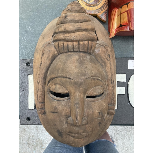 207 - A GROUP OF FIVE VINTAGE TRIBAL WOODEN MASKS