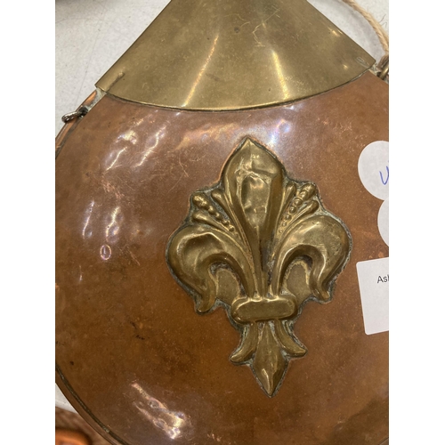 822 - A VINTAGE BRASS AND COPPER HIP FLASK WITH FLEUR DE LIS DESIGN