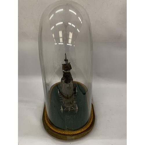 15 - A VINTAGE WHITE METAL, POSSIBLY SILVER, BOAT MODEL IN VINTAGE GLASS DOME CASE, DOME HEIGHT 46CM