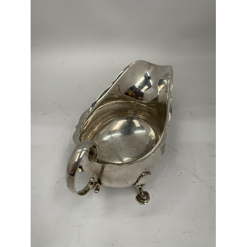 27 - A HALLMARKED SILVER SAUCE / GRAVY BOAT ON HOOF DESIGN FEET