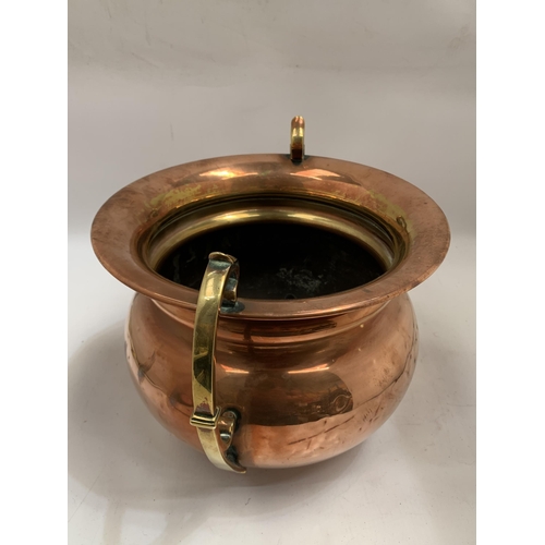 38 - A VINTAGE BRASS AND COPPER TWIN HANDLED POT