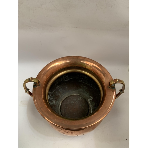 38 - A VINTAGE BRASS AND COPPER TWIN HANDLED POT