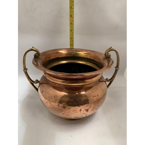 38 - A VINTAGE BRASS AND COPPER TWIN HANDLED POT