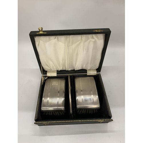 4 - A VINTAGE CASED BIRMINGHAM HALLMARKED SILVER TWIN BRUSH AND COMB SET