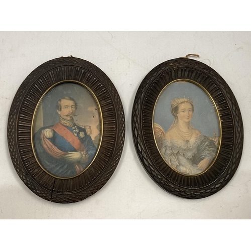 51 - A PAIR OF CARVED WOODEN PORTRAIT MINIATURES