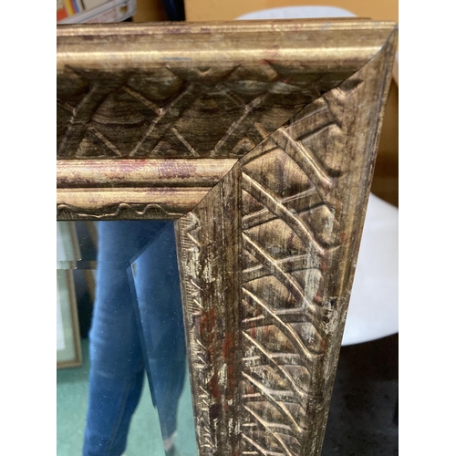 60 - A LARGE GILT FRAMED BEVEL EDGED WALL MIRROR, 73 X 104CM