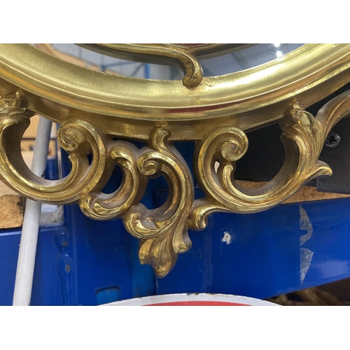 75 - A DECORATIVE GILT FRAMED OVAL MIRROR