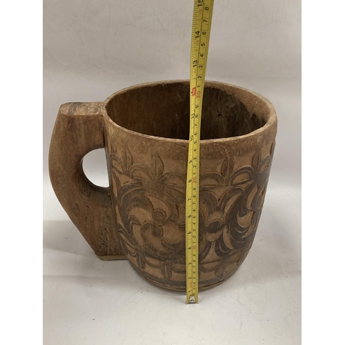 81 - A LARGE VINTAGE TRIBAL WOODEN MUG, HEIGHT 25CM