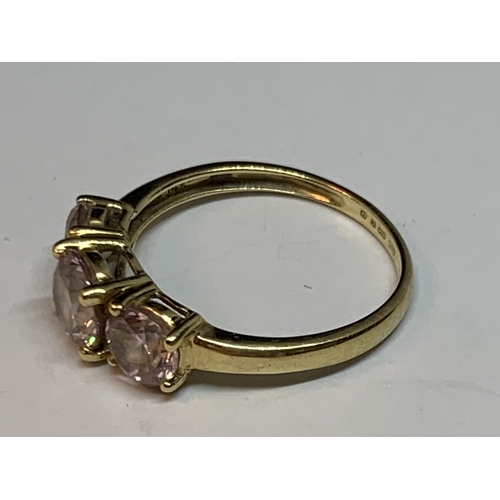 512 - A 14 CARAT GOLD RING WITH THREE IN LINE PINK STONES SIZE M/N