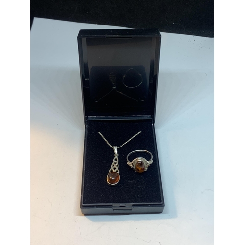 658 - A SILVER NECKLACE WITH AMBER PENDANT AND MATCHING RING WITH A PRESENTATION BOX