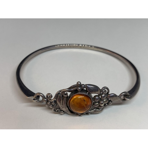 667 - A SILVER BANGLE WITH AMBER STONE AND A MATCHING RING