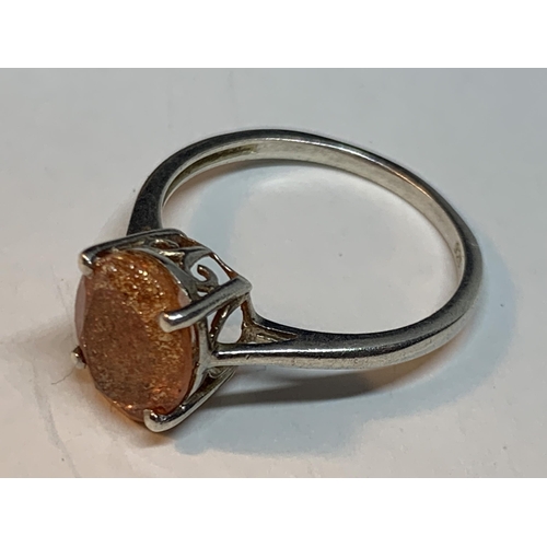 667 - A SILVER BANGLE WITH AMBER STONE AND A MATCHING RING