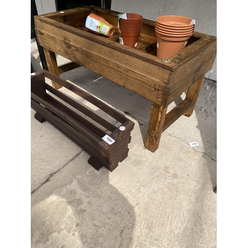 1694 - A WOODEN PLANTER, A SMALL WOODEN TROUGH AND VARIOUS PLASTIC PLANT POTS