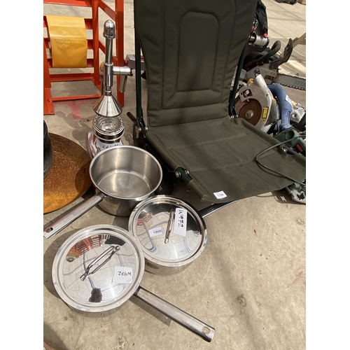 1800 - THREE STAINLESS STEEL COOKING PANS AND A JUICE PRESS