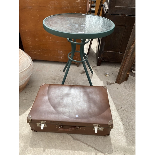 1853 - A GLASS TOPPED BISTRO TABLE AND A TRAVEL CASE