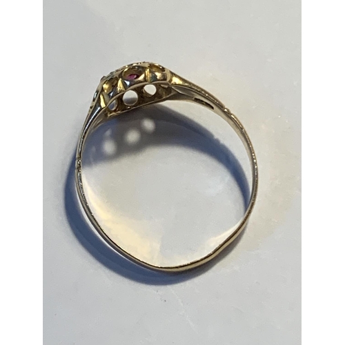 509A - AN 18 CARAT GOLD RING WITH CENTRE RUBY SURROUNDED BY SEVEN DIAMONDS SIZE Q/R GROSS WEIGHT 2.58 GRAMS