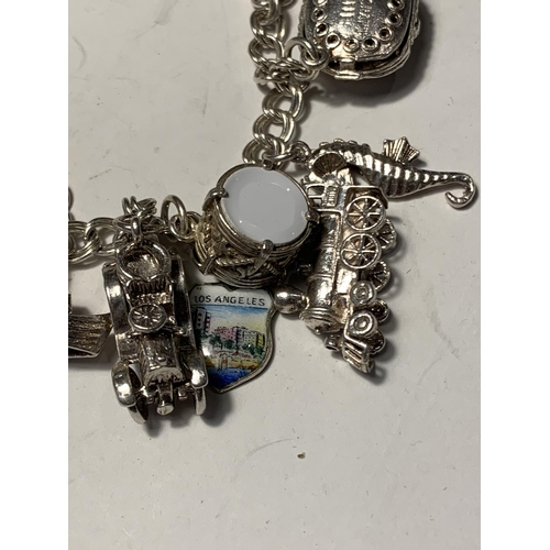 681A - A SILVER CHARM BRACELET WITH FOURTEEN CHARMS