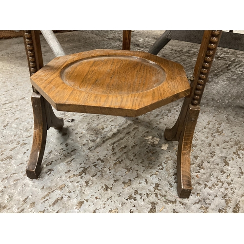 859 - A VINTAGE OAK CAKE STAND WITH THREE HEXAGONAL TIERS