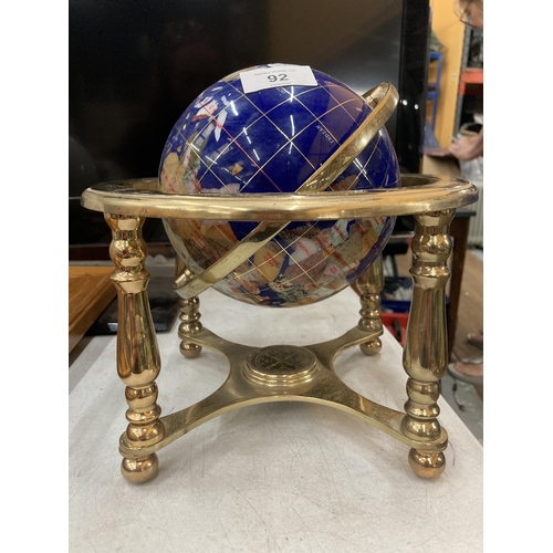 92 - A GEMSTONE GLOBE ON A BRASS BASE