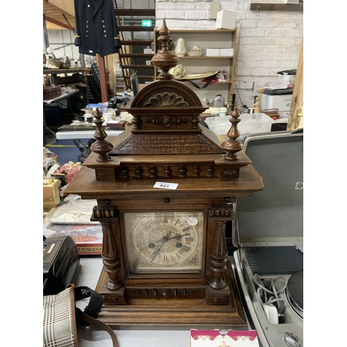 941 - A LARGE MAHOGANY CASED MANTLE CLOCK WITH COLUMN CARVING, IN NEED OF RESTORATION