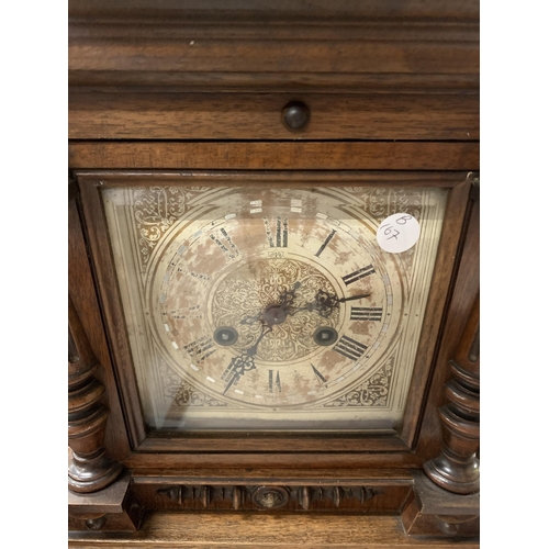 941 - A LARGE MAHOGANY CASED MANTLE CLOCK WITH COLUMN CARVING, IN NEED OF RESTORATION