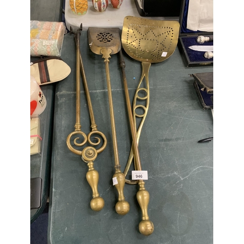 946 - FOUR LARGE PIECES OF BRASSWARE TO INCLUDE A POKER, TONGS, SKILLET AND SHOVEL