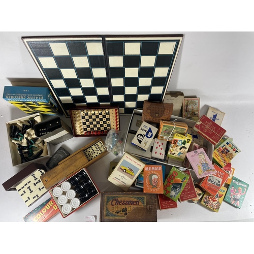 316 - A QUANTITY OF BOXED VINTAGE DOMINOES AND CHESS PIECES AND A BOX OF VINTSGE PLAYING CARDS