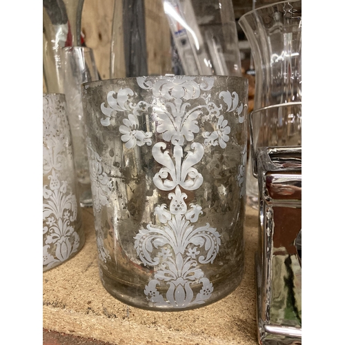 1021 - A QUANTITY OF GLASSWARE VASES AND CANDLE HOLDERS