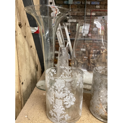 1021 - A QUANTITY OF GLASSWARE VASES AND CANDLE HOLDERS