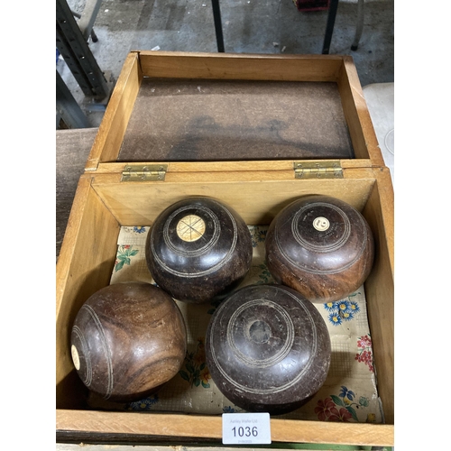 1036 - A VINTAGE PINE BOX CONTAINING FOUR BOWLING BOWLS