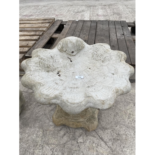 134 - A CONCRETE SHELL BIRDBATH WITH A DECORATIVE BASE NO VAT