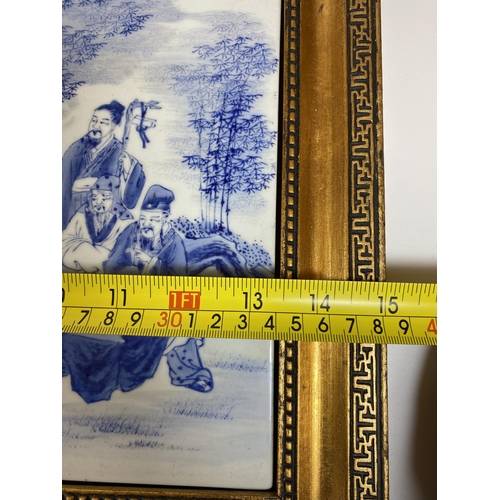 386 - A GILT FRAMED CHINESE BLUE AND WHITE PORCELAIN PLAQUE WITH SCHOLAR FIGURES DESIGN, SIGNED TO TOP LEF... 