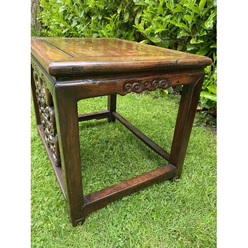 451 - AN ANTIQUE CHINESE HUANGHUALI STYLE CARVED ROSEWOOD LAMP TABLE WITH DRAGON DESIGN FRONT, 51 X 62 X 4... 