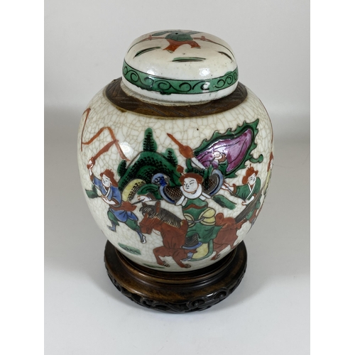 452 - A LATE 19TH/EARLY 20TH CENTURY CHINESE CRACKLE GLAZE WARRIOR DESIGN GINGER JAR ON CARVED WOODEN BASE... 