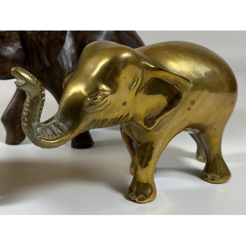 462 - A GROUP OF THREE ELEPHANT FIGURES TO INCLUDE TWO CARVED WOODEN AND A SOLID HEAVY BRASS EXAMPLE, LARG... 