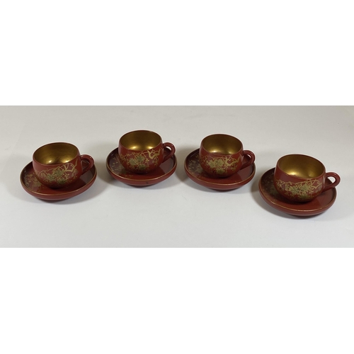 465 - A SET OF FOUR ORIENTAL RED AND GILT LACQUERED CUPS AND SAUCERS, SAUCER DIAMETER 9.5CM