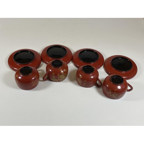 465 - A SET OF FOUR ORIENTAL RED AND GILT LACQUERED CUPS AND SAUCERS, SAUCER DIAMETER 9.5CM