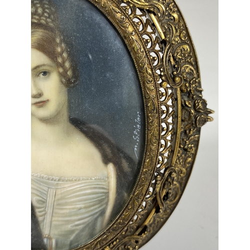 6 - AN EARLY 19TH CENTURY HAND PAINTED PORTRAIT OF A LADY, SIGNED M.STIELER, IN ORNATE BRASS OVAL FRAME ... 