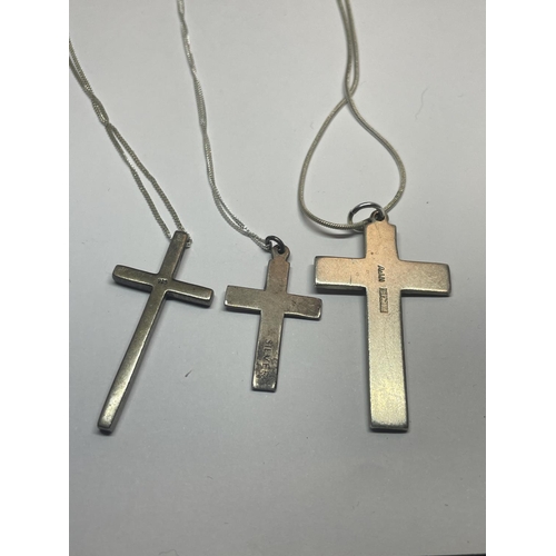 522 - THREE SILVER NECKLACES WITH CROSS PENDANTS