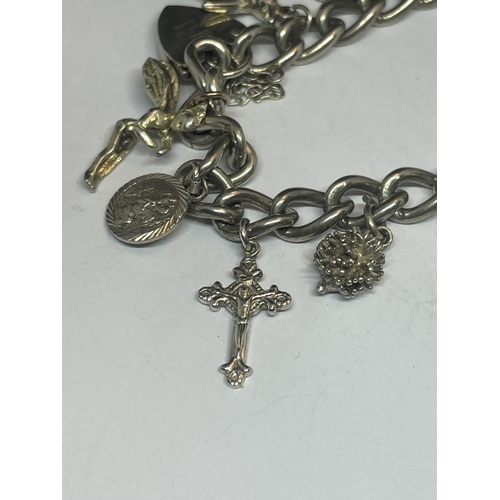 530 - A SILVER CHARM BRACELET WITH TEN CHARMS AND A HEART PADLOCK