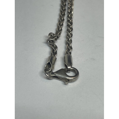 533 - A SILVER NECKLACE WITH TRUMPET PENDANT IN A PRESENTATION BOX